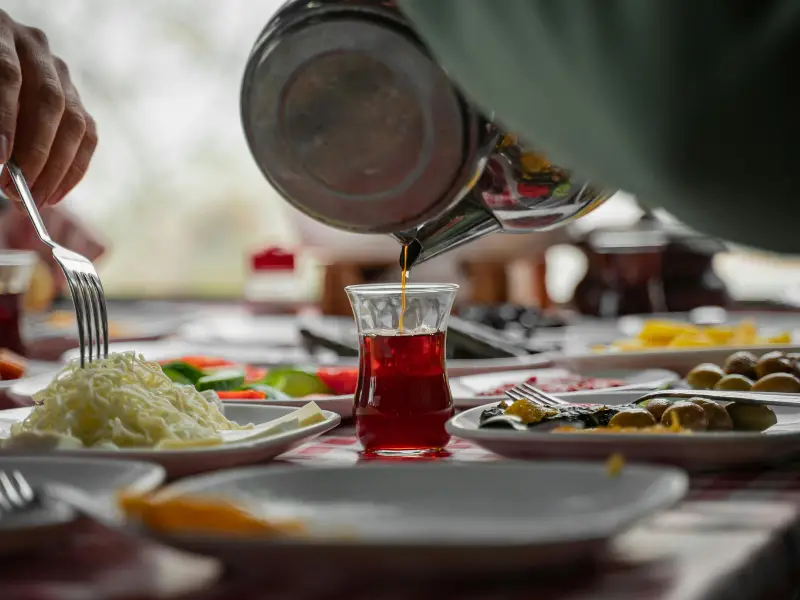 Traditional Turkish breakfast table with cheese, olives, eggs, bread and tea in Istanbul