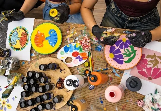Participants painting colorful ceramic plates during a workshop in Istanbul