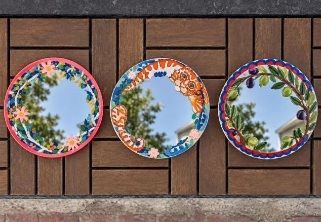 Three handmade painted mirrors with floral and animal designs