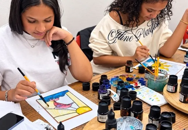Participants painting colorful stained glass designs at an Istanbul workshop