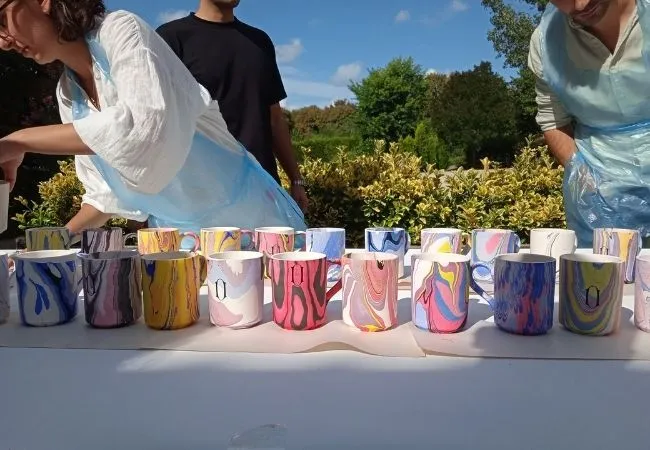 Handmade ceramic mugs decorated with colorful marbling patterns