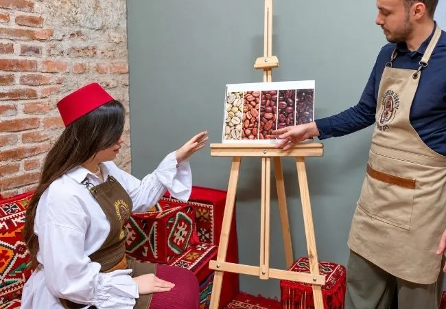 Instructor explaining Turkish coffee beans during a traditional coffee workshop