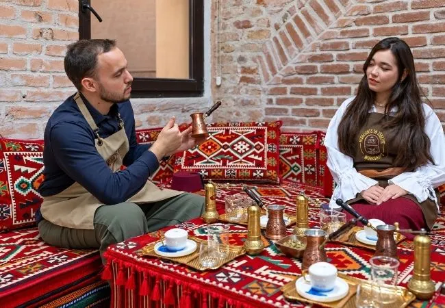 Instructor explaining traditional Turkish coffee preparation during a workshop in Istanbul