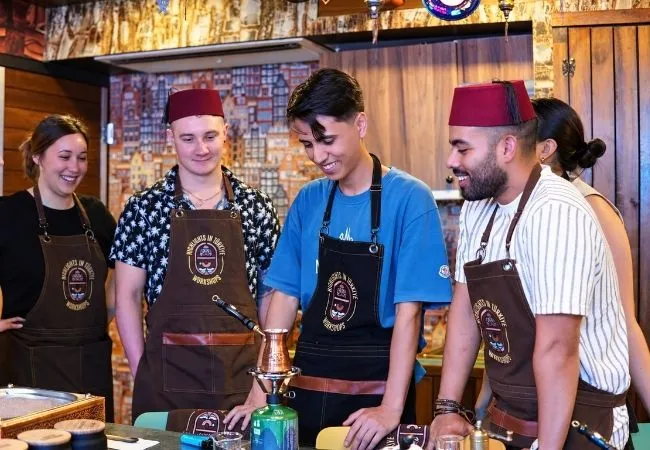 Participants learning how to make Turkish coffee in an Istanbul workshop